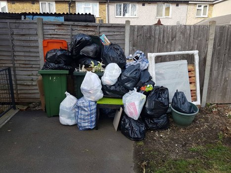 Front view of a skip on residential street for waste collection