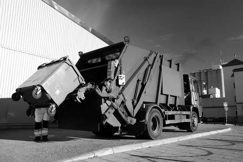 Skip hire truck parked on a residential Bromley street next to terraced houses